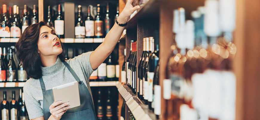 Woman looking at shelves of wine